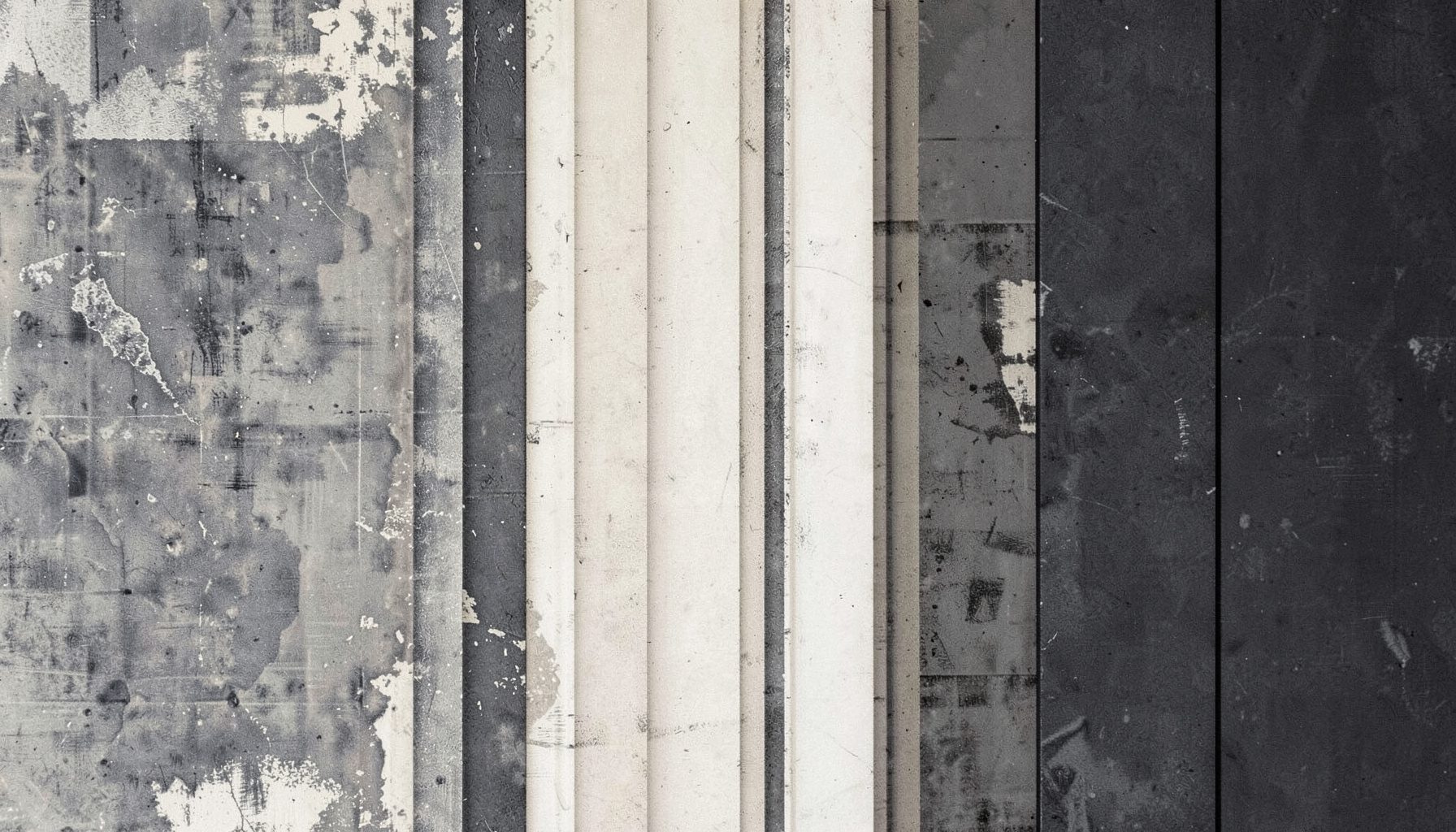 A textured abstract composition in muted charcoal, slate grey, and cream, suggesting layered sonic fragments and weathered surfaces